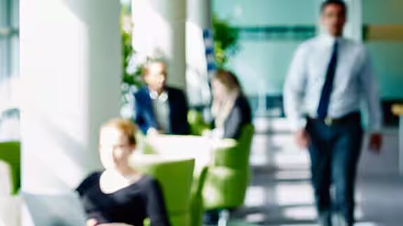 Blurry shot of a group of people hanging out in the office lobby