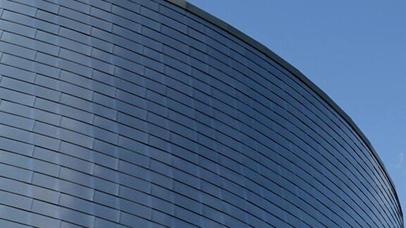 Modern building with abstract architecture set against a sunny sky