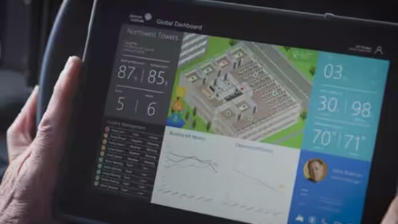 Close up of a person holding a tab and viewing the dashboard of his chiller performance