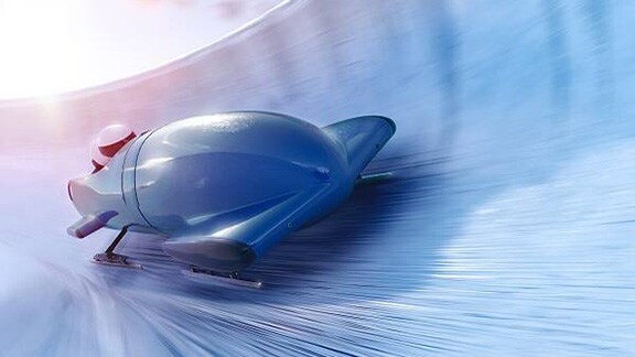 A bobsleigh racer racing along an icy track