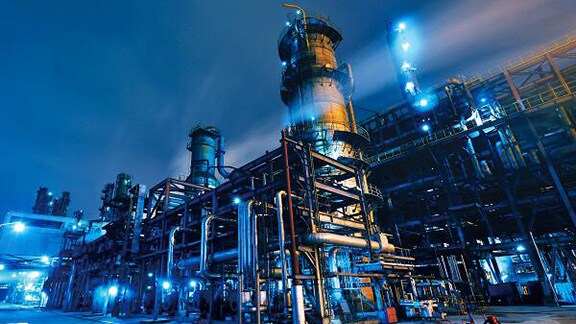 A petrochemical refinery lit up at dusk