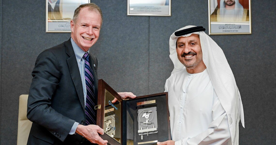 George Oliver and Khalid Abdulla Al Marzooqi hold up a plaque celebrating their collaboration