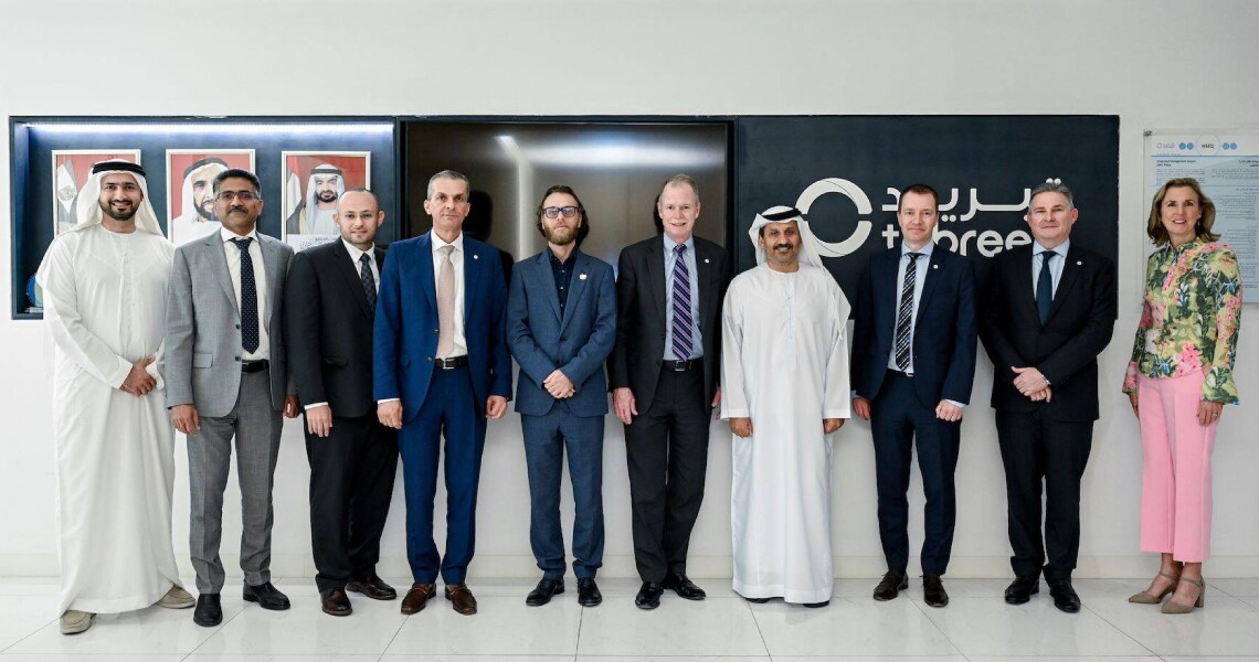 Teams from Johnson Controls and Tabreed posing in Tabreed's office