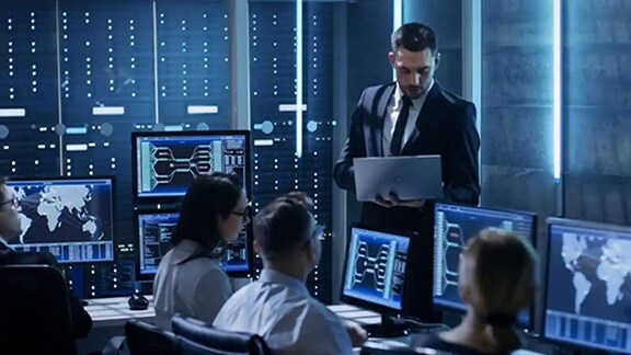 People working inside a control room