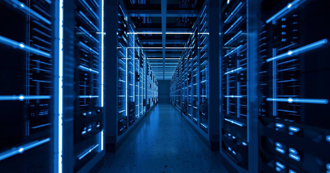 Inside of a dimly lit server room in a data centre
