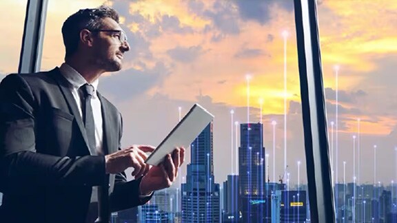 Man looking out at the city which is overlaid with graphics of transmission node