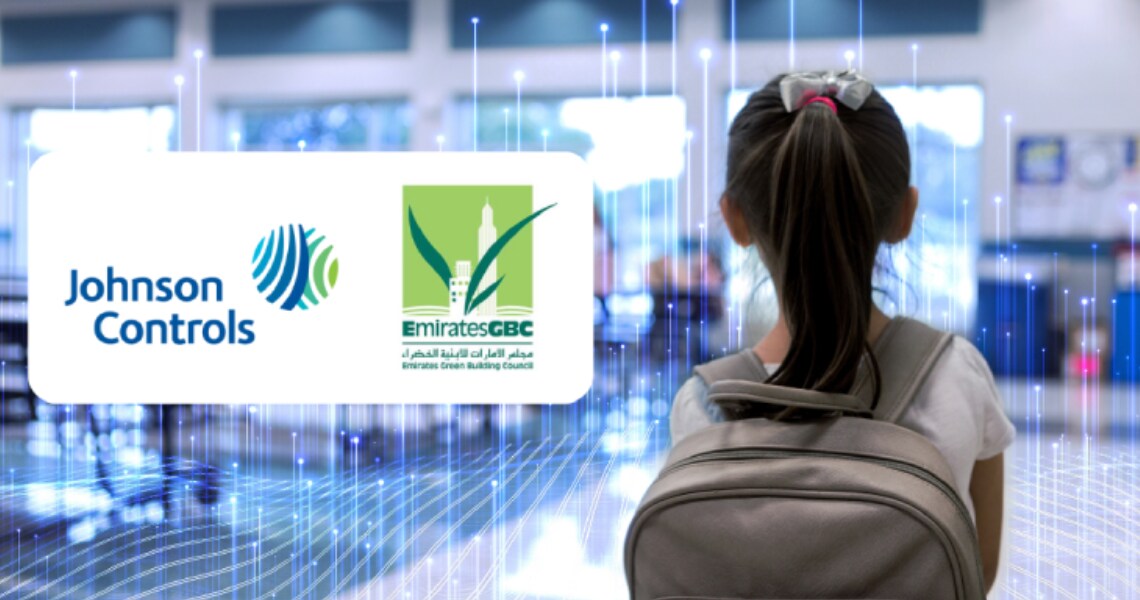 Logo depicting partnership of Johnson Controls and Emirates Green Building Council, overlaid on a image of kid in school