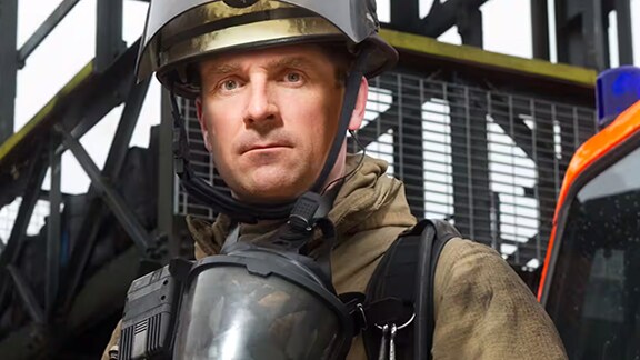 Fire fighter in safety equipment and face mask
