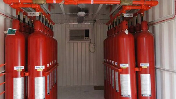 Fire suppression systems in a cylinder storage enclosure