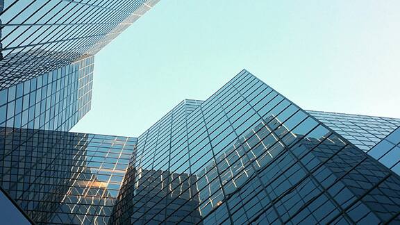 Frog's eye view of glass buildings against the sky