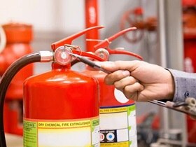 Engineer testing a fire extinguisher