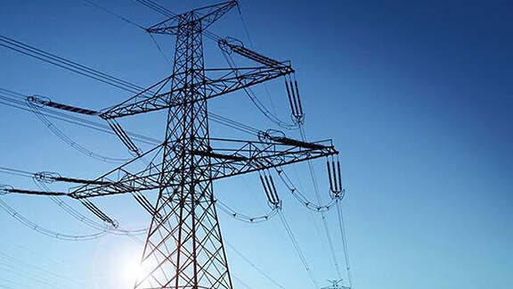 Electric power transmission cables against a clear sky