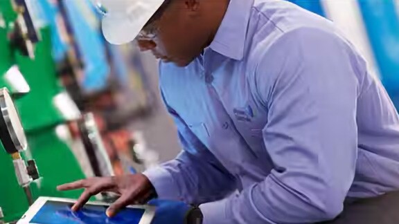 Johnson Controls worker noting chiller readings on a tab