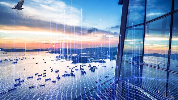 Aerial view of a lake, with a skyscraper in the foreground
