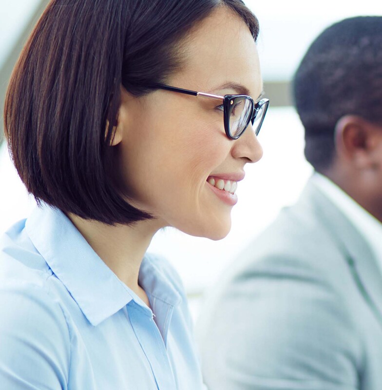 Corporate employees seated in a room and smiling