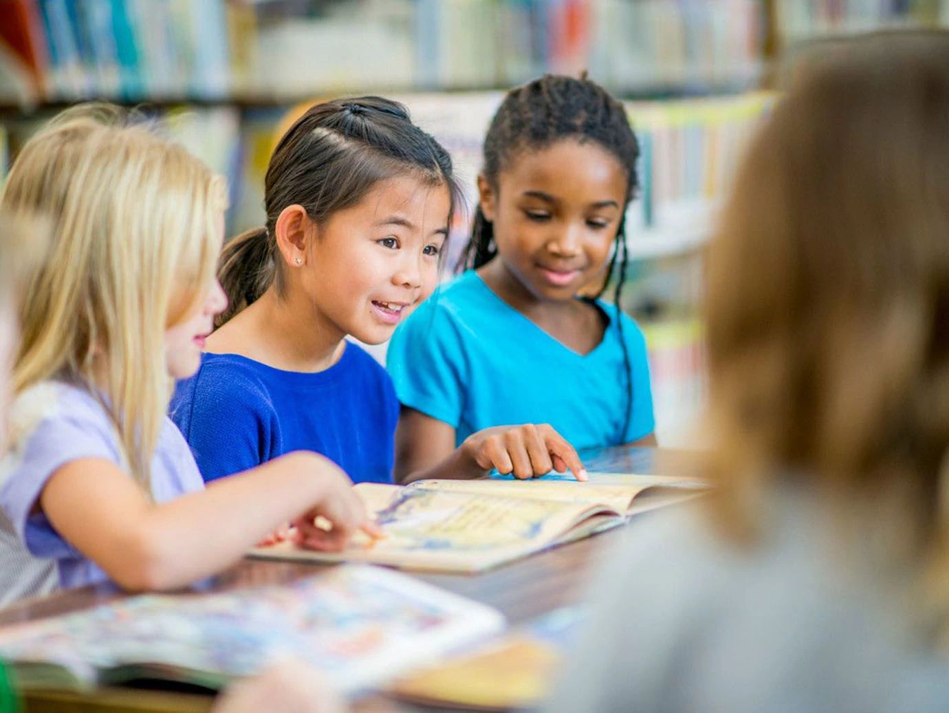 A group of young female students sitting at a table and talking