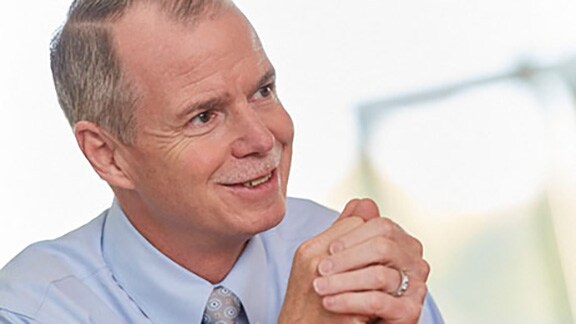 George Oliver, CEO of Johnson Controls, smiling during an interview 