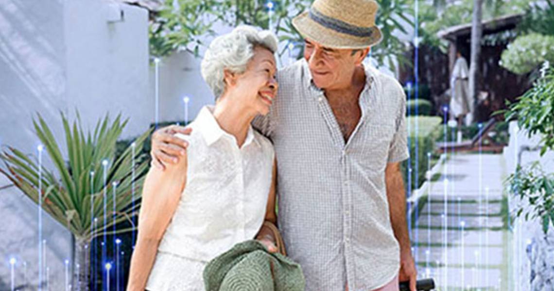 A couple walking together while dragging suitcases behind them