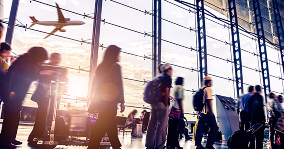 Passengers walking along a passage in an airport terminal