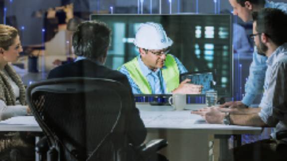 A mechanic demonstrating something to businesspeople