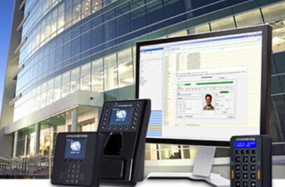 A laptop and various devices overlaid in front of a commercial building