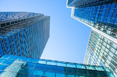 Frog's eye view of glass buildings against the sky
