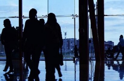 Silhouette of people walking inside a building