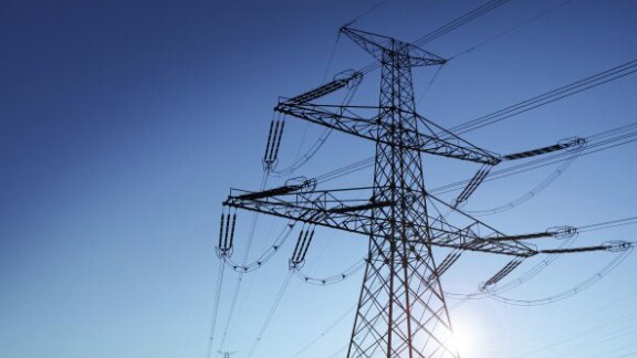 An electricity tower against the sky during the day