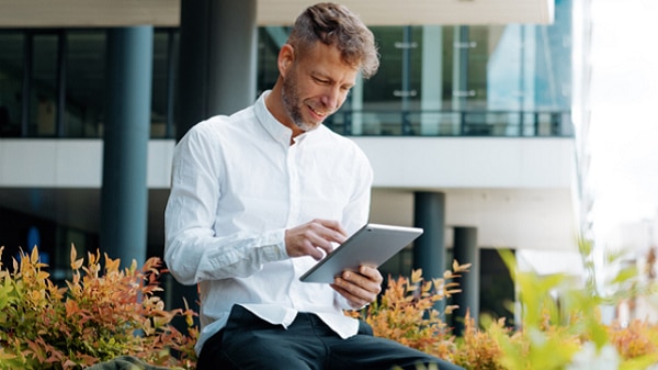 Man sitting and using his tablet