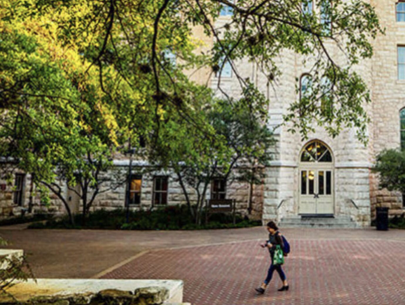 A student walking along a university campus