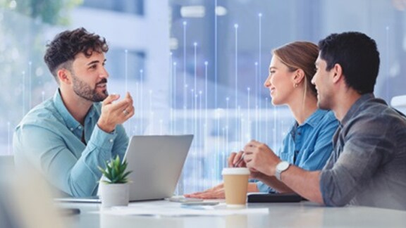 Three people in discussion at a table