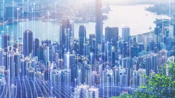 Aerial view of a cityscape, overlaid with OpenBlue graphics