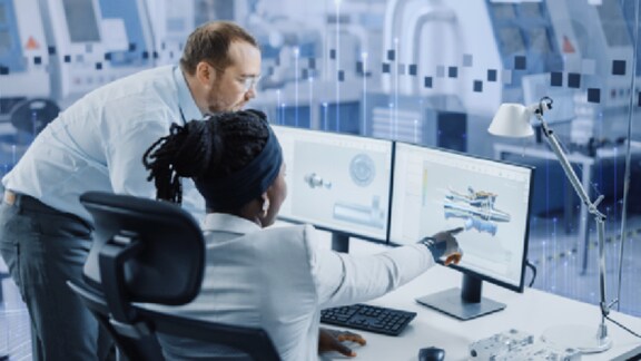 A woman pointing something on a computer to a man beside her