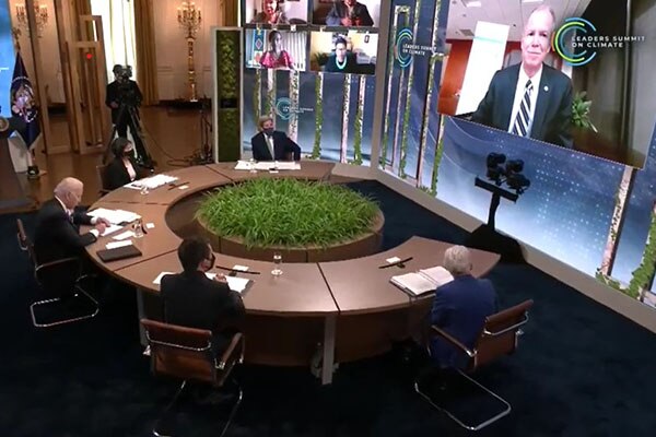 George Oliver, Chairman & CEO, Johnson Controls speaking over a online call in front of President Biden and other leaders in April 2021