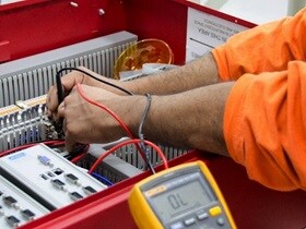 Engineer testing and repairing electrical panels